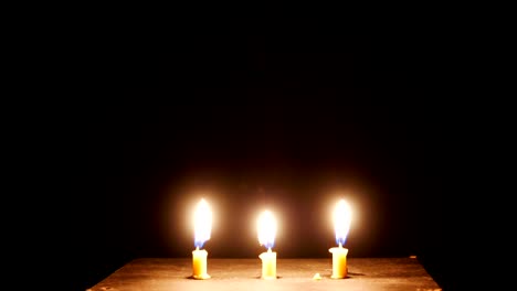 time-lapse,Close-up-candle-is-burning-on-black-background.