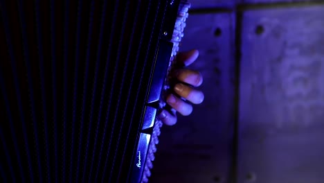 Close-up-of-a-man's-left-hand-playing-on-a-black-accordion.