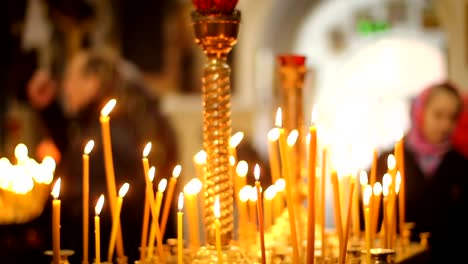 People-praying-and-crossing-in-front-of-icons,-asking-for-health-and-blessing