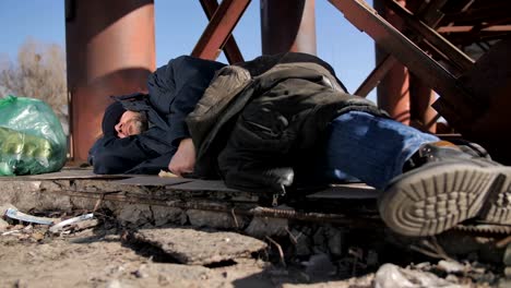 Close-up-feet-of-homeless-man-sleeping-outdoors