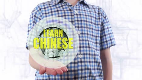 Young-man-shows-a-hologram-of-the-planet-Earth-and-text-Learn-Chinese