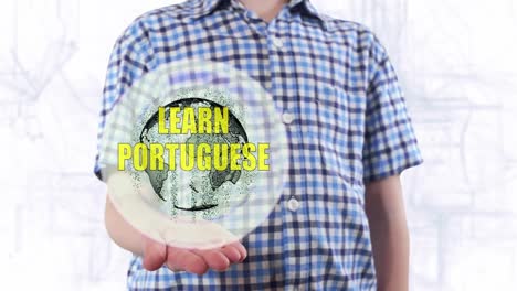 Young-man-shows-a-hologram-of-the-planet-Earth-and-text-Learn-Portuguese