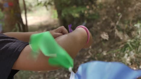 Young-kids-in-summer-camp-crafting-art-painting-outside-playing-outdoor-in-park-under-trees-slow-motion