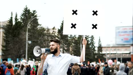 Man-at-a-political-rally-with-banner-with-points-for-tracking-to-copy-space-text