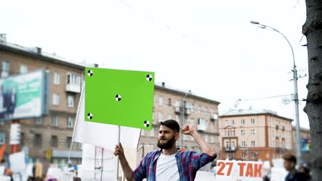 Young-adult-man-waves-his-hand-at-a-rally.-The-revolution-in-Europe-slow-motion.