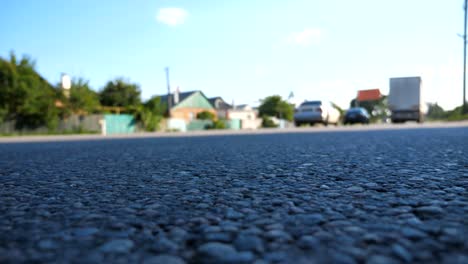 Blurred-cars-go-one-by-one-on-the-road.-Vehicles-drive-along-asphalt-road.-Traffic-in-highway.-Low-angle-view-Slow-motion