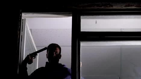 Depressed-male-opening-window-and-aiming-at-his-head-with-handgun,-suicide