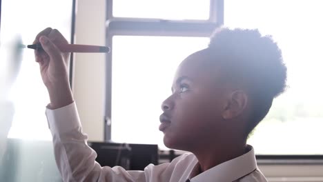 Female-High-School-Student-Wearing-Uniform-Using-Interactive-Whiteboard-During-Lesson