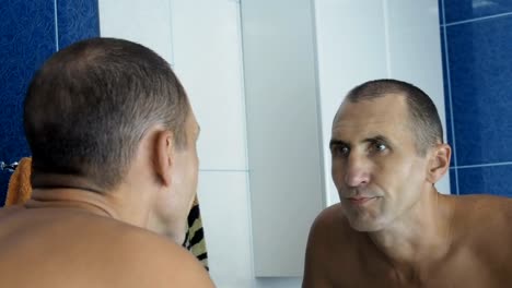 Angry-man-at-the-mirror.