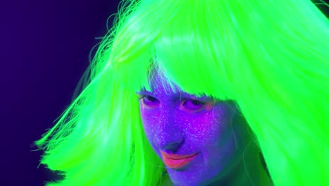 Langsame-Motin-von-schönen-sexy-Frauen-mit-fluoreszierenden-Make-up-und-Kleidung-Tanz-im-Neonlicht.-Night-Club,-Party-Konzept.