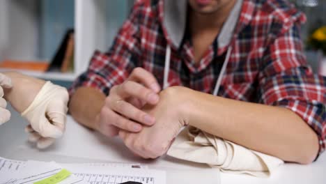 Close-up-of-the-patient-shows-the-doctor-inflammation-or-growth-on-the-wrist.