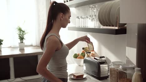 Frau,-die-Toasts-auf-Frühstück-modernen-leichten-Küche-kochen