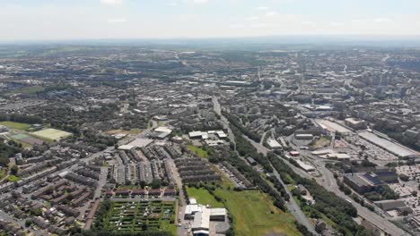 Aerial-footage-of-the-British-West-Yorkshire-town-of-Bradford,-showing-typical-British-streets,-road,-businesses-and-houses,-taken-with-a-drone-on-a-bright-sunny-summers-day