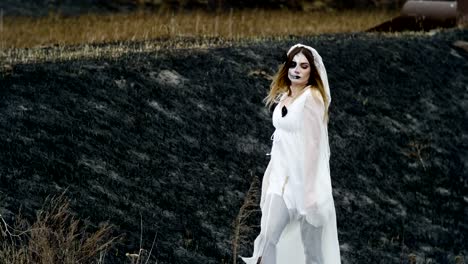 Girl-with-spooky-make-up-of-dead-bride-for-Halloween-dressed-in-wedding-gown.-4K