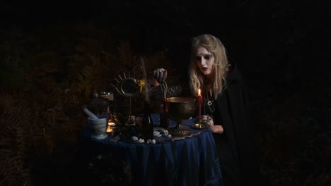 Halloween.-Young-Witch-Spells-At-The-Table.