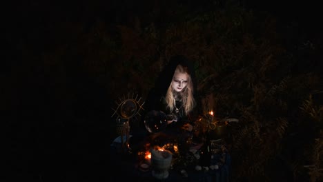 Halloween.-Young-Witch-Spells-At-The-Table.