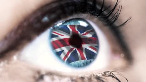 woman-blue-eye-in-close-up-with-the-flag-of-United-kingdom-in-iris-with-wind-motion.-video-concept