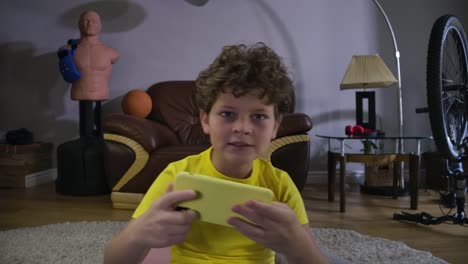 Little-Caucasian-boy-with-red-tired-eyes-looking-at-the-screen-and-using-smartphone.-Caucasian-teenage-kid-having-games-addiction.-Technologies,-internet,-video-games.-Cinema-4k-ProRes-HQ.