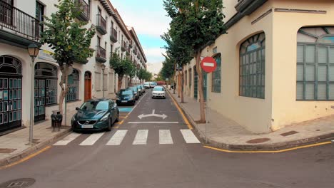 Tenerife,-Canary-Islands,-Spain---January,-2019:-Typical-street-of-a-European-city.-The-car-is-approaching-the-road.-Traffic-sign-in-foreground---no-traffic.-Can-be-used-to-illustrate-spain,-portugal