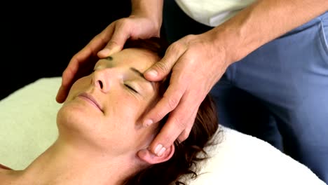 Physiotherapist-giving-head-massage-to-a-female-patient