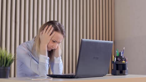 Overwhelmed,-sad-businesswoman-with-documents-and-laptop-in-home