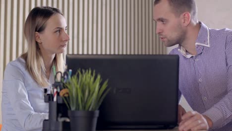 Worried-business-people-in-office-with-laptop-and-documents