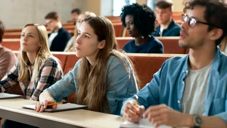 Group-of-Multi-Ethnic-Students-in-Classroom-Listening-to-a-Lecture-and-Taking-Notes.-Bright-Young-People-Study-at-University.