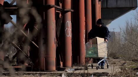 Homeless-man-taking-plastic-bottle-to-recycle