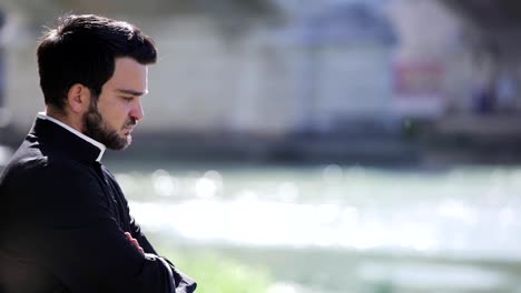 profile-of-votary-Young-Priest-Praying-near-the-river--outdoor