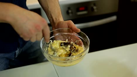 A-man-mixes-ingredients-to-prepare-a-paste-of-Carbonara