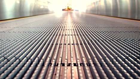 Close-up-of-Moving-walkway-moving-toward-the-light-at-air-port