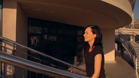 woman-in-black-dress-is-going-up-the-staircase