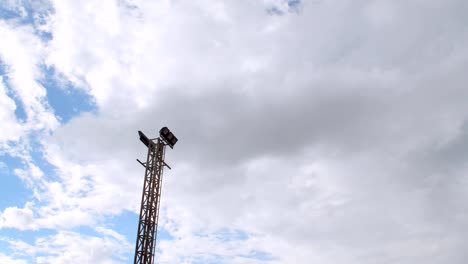 Electric-spotlight-pole-with-blue-sky-background,-time-lapse.