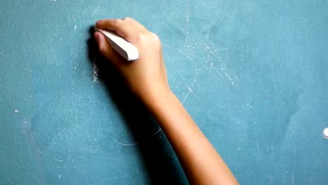 Child's-hand-writes-on-the-chalkboard-words-"Back-to-School!"