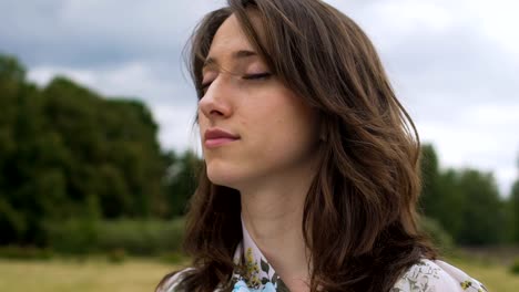 Meditation-outdoors-young-woman-feels-oneness-with-world-nature,-inner-peace