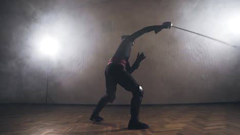 Medieval-warrior-training-with-sword-indoors-in-slow-motion