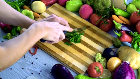 Man-is-chopping-parsley-on-cutting-board