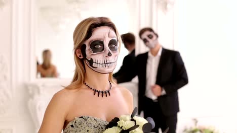 Creepy-couple-with-scary-Halloween-makeup-in-vintage-costumes-in-a-studio.