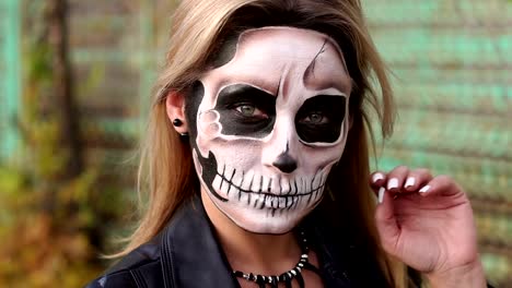 A-bride-with-a-creepy-skull-makeup-for-Halloween-in-an-abandoned-city.