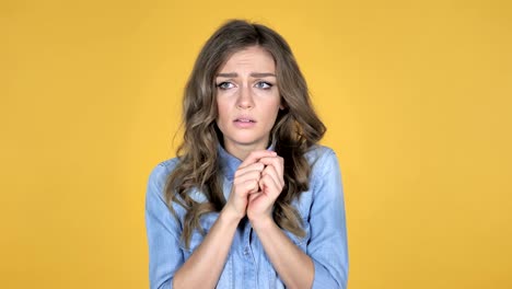 Young-Girl-Confused-and-Scared-of-Problems-Isolated-on-Yellow-Background