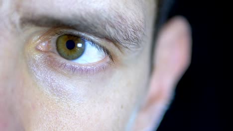 Serious-Look-of-a-Young-Man-who-Concentrated-Works-on-a-Black-Background