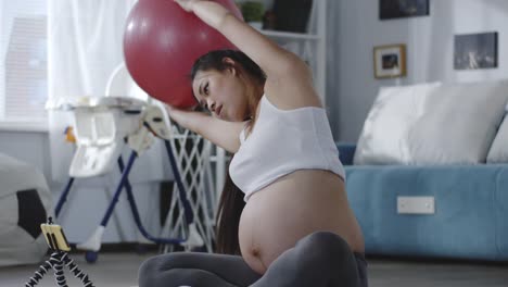 Pregnant-woman-watching-tutorial-video-during-workout