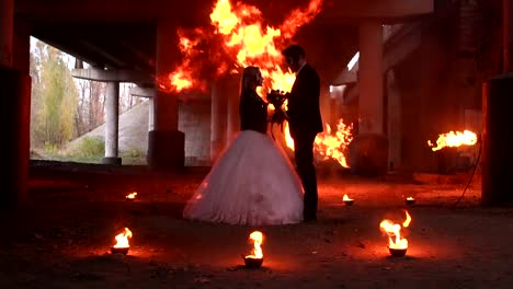 Couple-with-a-terrible-makeup-for-Halloween,-in-the-background-a-huge-flame.