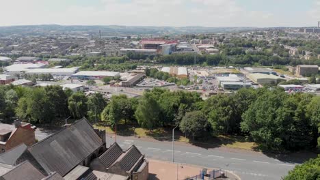 Aerial-footage-of-the-British-West-Yorkshire-town-of-Bradford,-showing-typical-British-streets,-road,-businesses-and-houses,-taken-with-a-drone-on-a-bright-sunny-summers-day