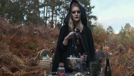 Halloween.-Young-Witch-Spells-At-The-Table.