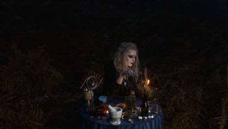 Halloween.-Young-Witch-Spells-At-The-Table.