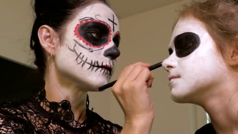 Mother-and-daughter-apply-Halloween-makeup