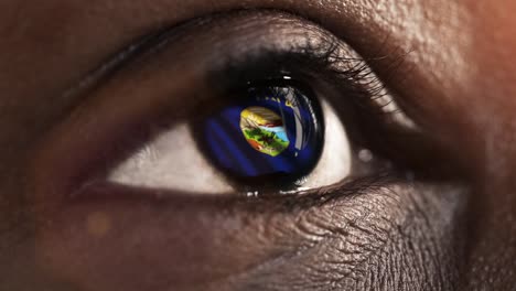 Woman-black-eye-in-close-up-with-the-flag-of-Montana-state-in-iris,-united-states-of-america-with-wind-motion.-video-concept