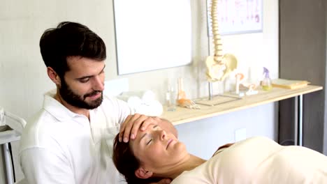 Physiotherapist-giving-head-massage-to-a-female-patient