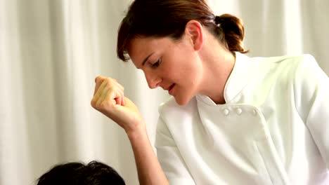 Physiotherapist-giving-back-massage-to-a-patient